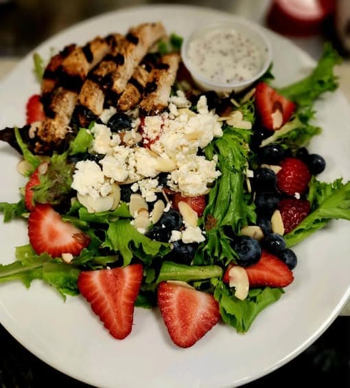 Summer berry salad with grilled chicken, feta, and almonds