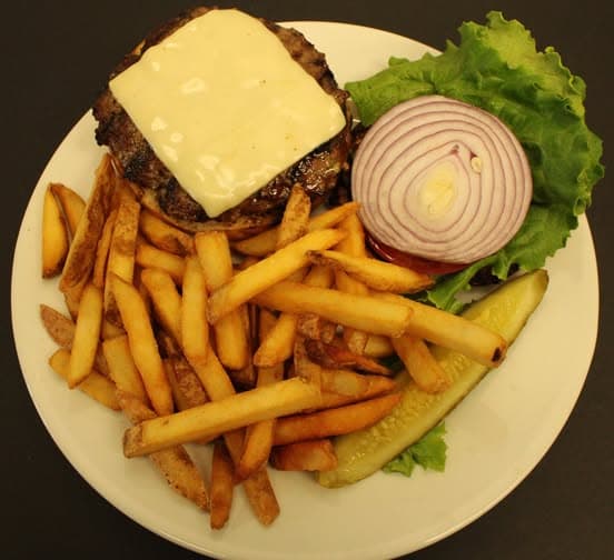 Tavern burger with lettuce, tomato, onion, and fries