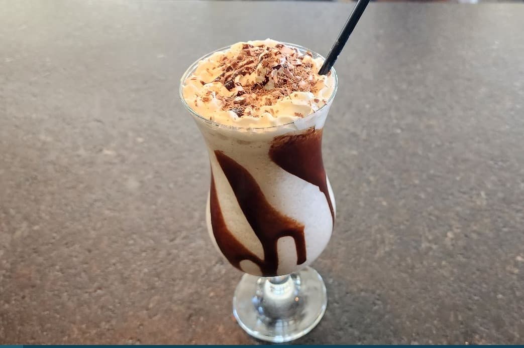 Chocolate mudslide with whipped cream and chocolate shavings